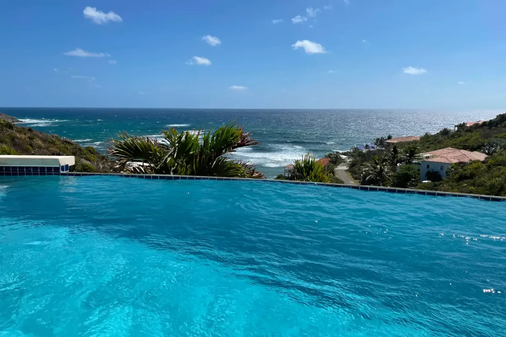 Your infinity pool meets the turquoise sea — swim where the sky touches the water.