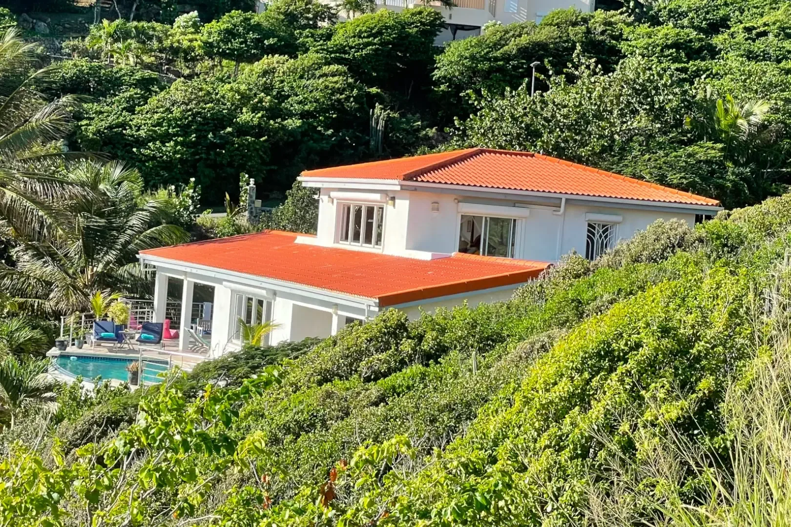 Dawn Beach Estates welcomes you — white walls, red roofs, and your private pool.