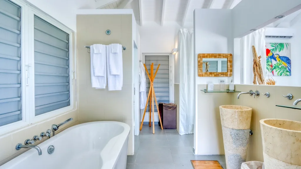 Bathroom detail with freestanding tub, towels, and wood accents