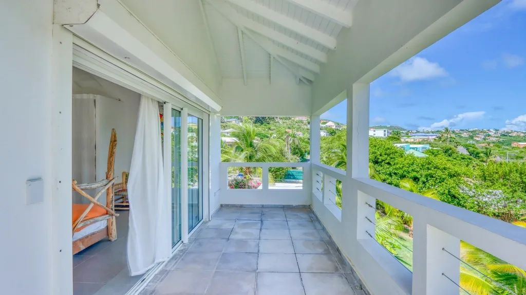Covered bedroom terrace corridor with railing and hillside view