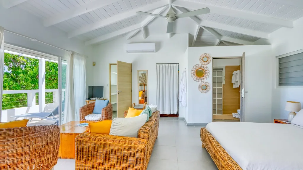 Fitness room lounge with wicker seating, daybed, and ceiling fan