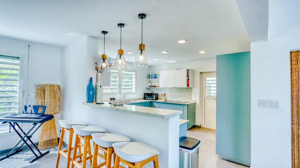 Bright kitchen with breakfast bar seating and pendant lights