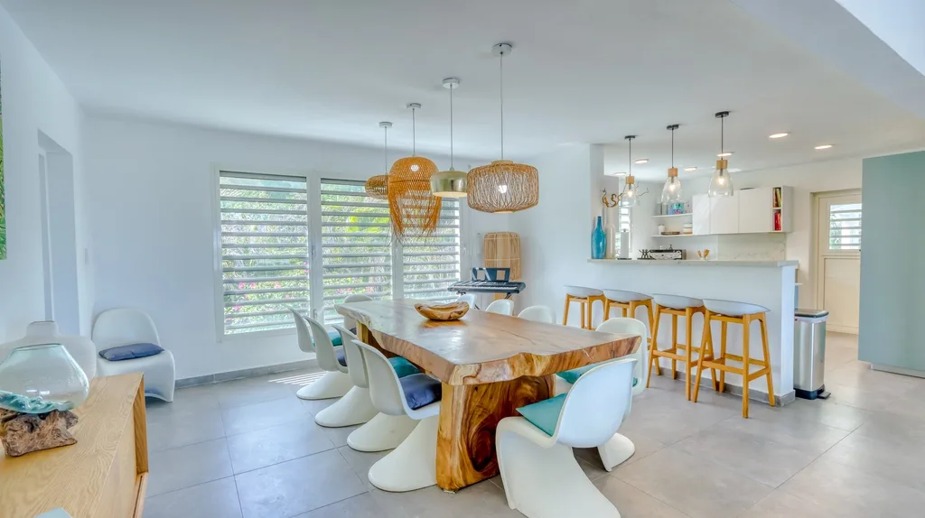 Kitchen and dining overview with breakfast bar and wood dining table