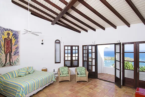 Wake up to the Caribbean — French doors frame an endless blue, and the morning light dances on vaulted ceilings.
