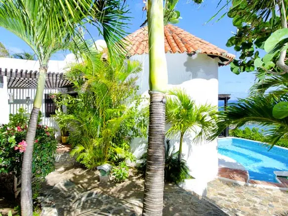 Your private infinity-edge pool melts into the Caribbean horizon — this is the view you came for.