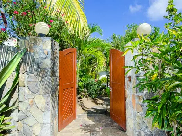 Grand stone pillars and warm lights welcome you home to your tropical retreat.