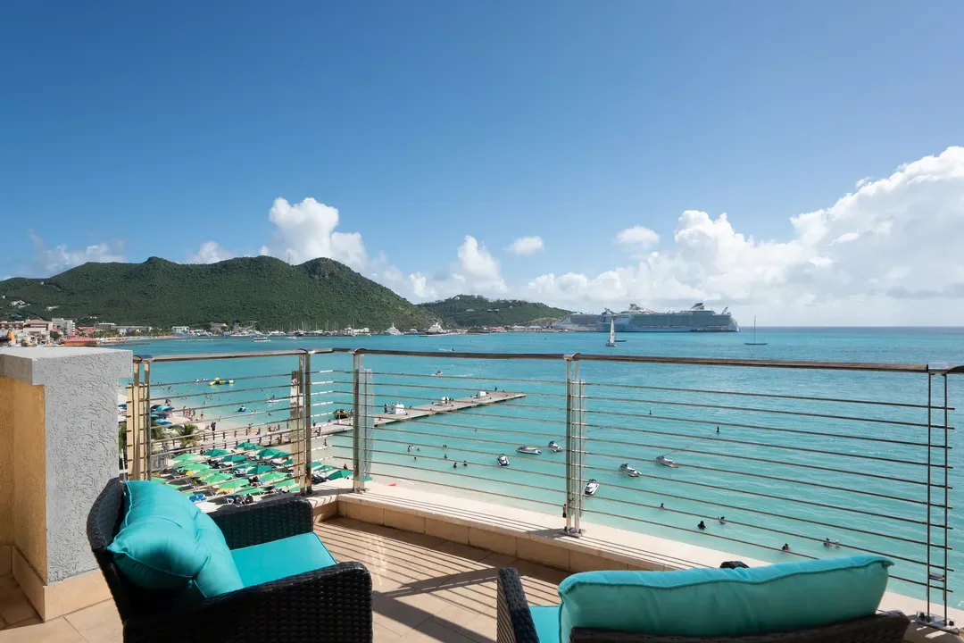 Your private balcony oasis — turquoise cushions, cable railings, and an unobstructed view of Great