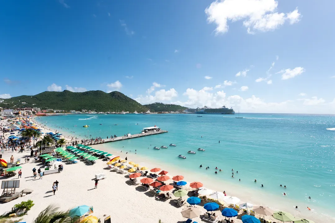 Step onto the sands of Great Bay — your private paradise awaits with turquoise waters, a scenic pier, and the iconic Caribbean cruise ship backdrop.
