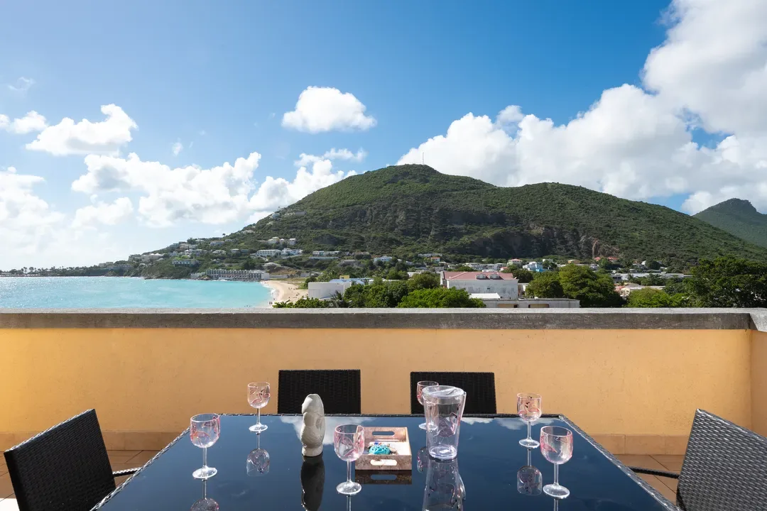 Sip your evening wine as the sun sets over Great Bay — coastal town lights twinkling against the mountain backdrop.