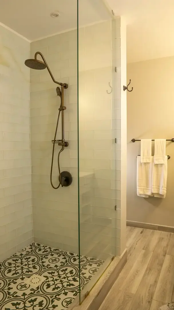 Walk-in glass shower with rain showerhead — rinse off the salt and sand in style.