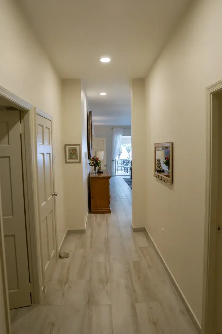 Light-filled hallway leads you toward the outdoor terrace and ocean breeze.
