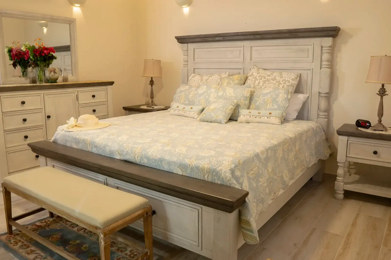 Coastal-themed master suite with wicker accents — sleep to the sound of palm trees.