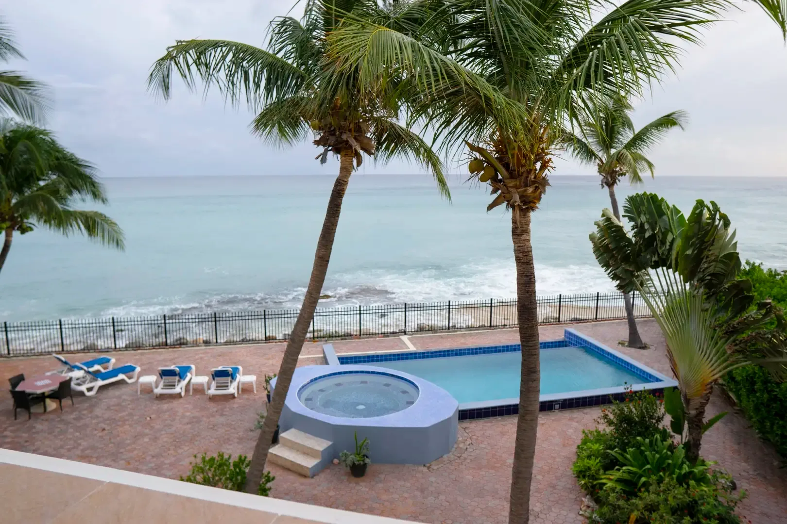 Your private infinity-edge pool meets the Caribbean — soak in the view from the terrace.