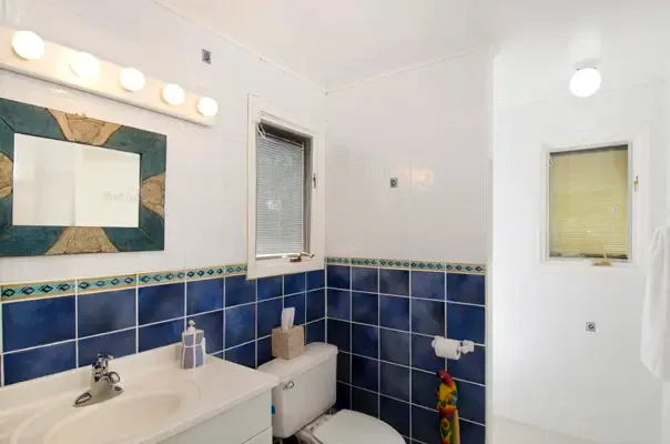 Bright bathroom with blue tile accents and a fresh coastal feel.