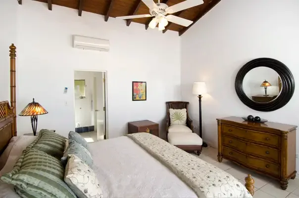 Comfortable island bedroom with warm wood tones and a restful retreat atmosphere.