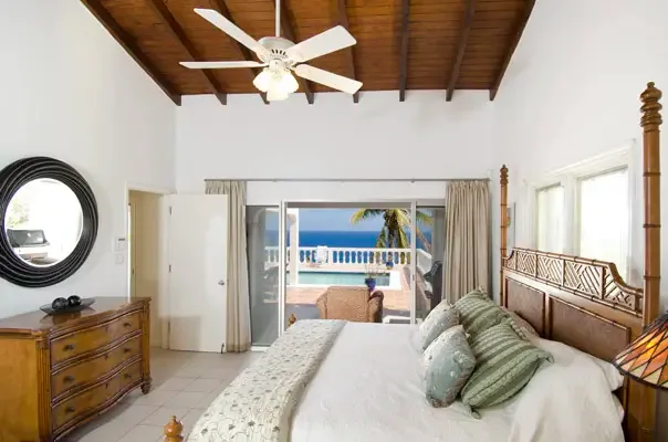 Peaceful master bedroom with ocean views and a serene retreat feel.