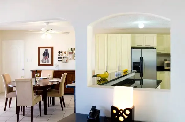 Open-plan dining and kitchen layout designed for easy gathering and effortless vacation living.