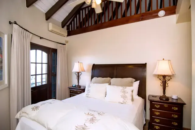 Wake up to French doors framing the ocean — rustic wooden beams and elegant touches create your serene escape.