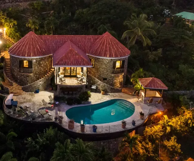Nightfall transforms your villa into a magical paradise — swim under the stars in your illuminated pool.