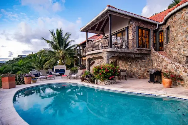 Lounge by your infinity-edge pool with panoramic hill views — the perfect spot for a sunset cocktail.