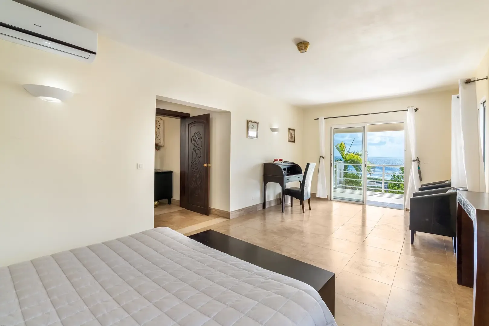 White curtains frame ocean views — your bedroom sanctuary.