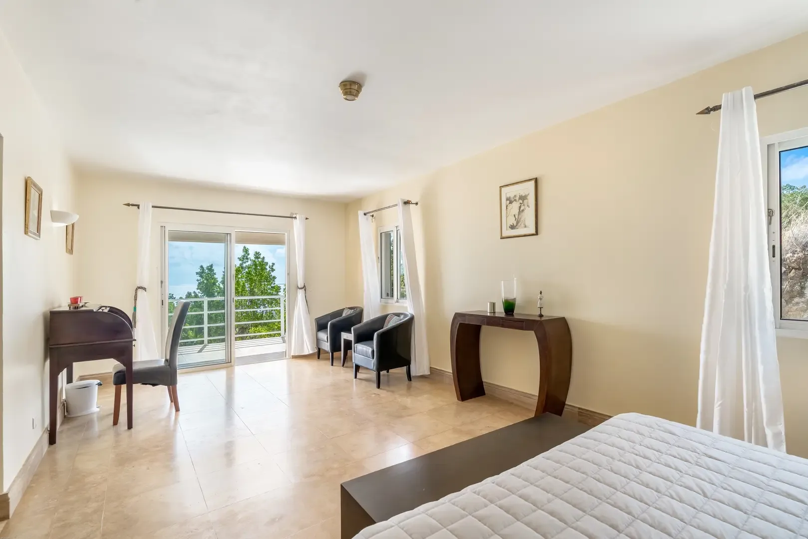 A serene bedroom with workspace — step onto your private balcony.