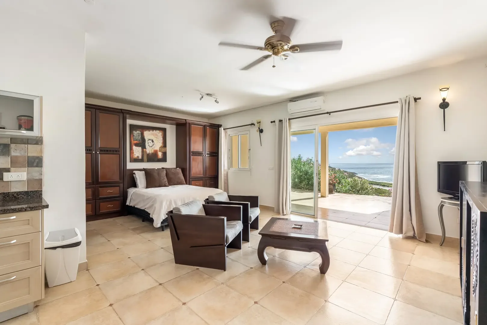 Bedroom opens to living area and balcony — flexible island living.