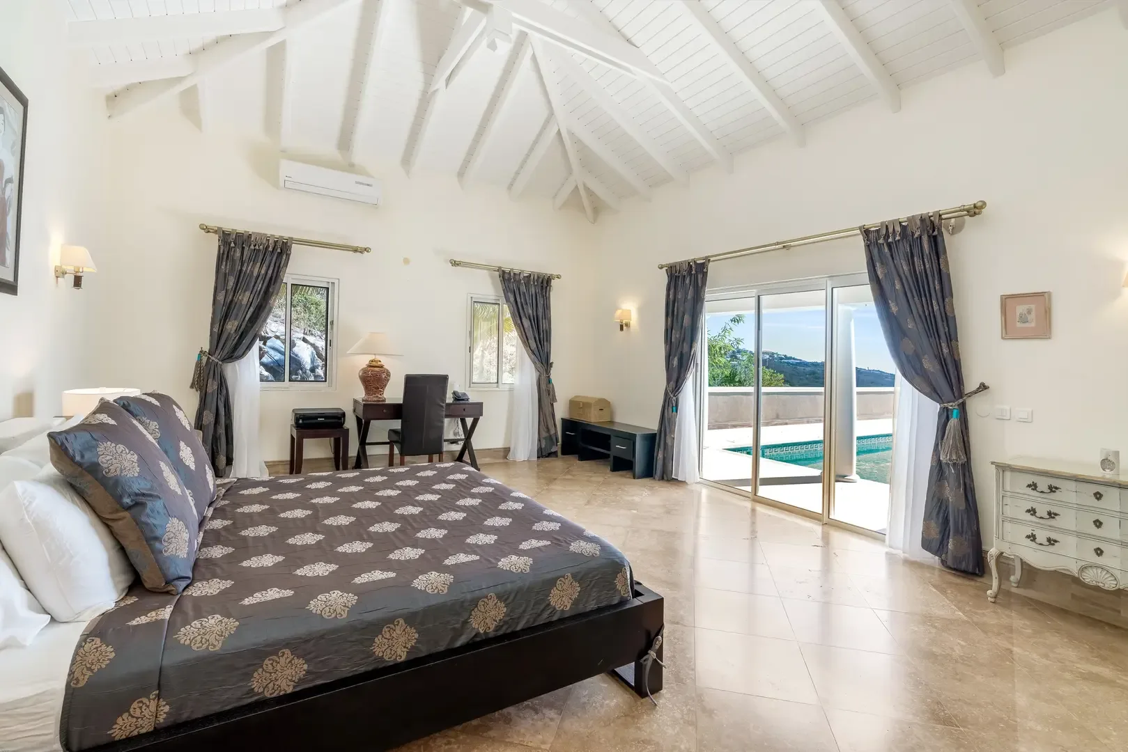 Step from bed to terrace — your bedroom opens to pool and outdoor views.