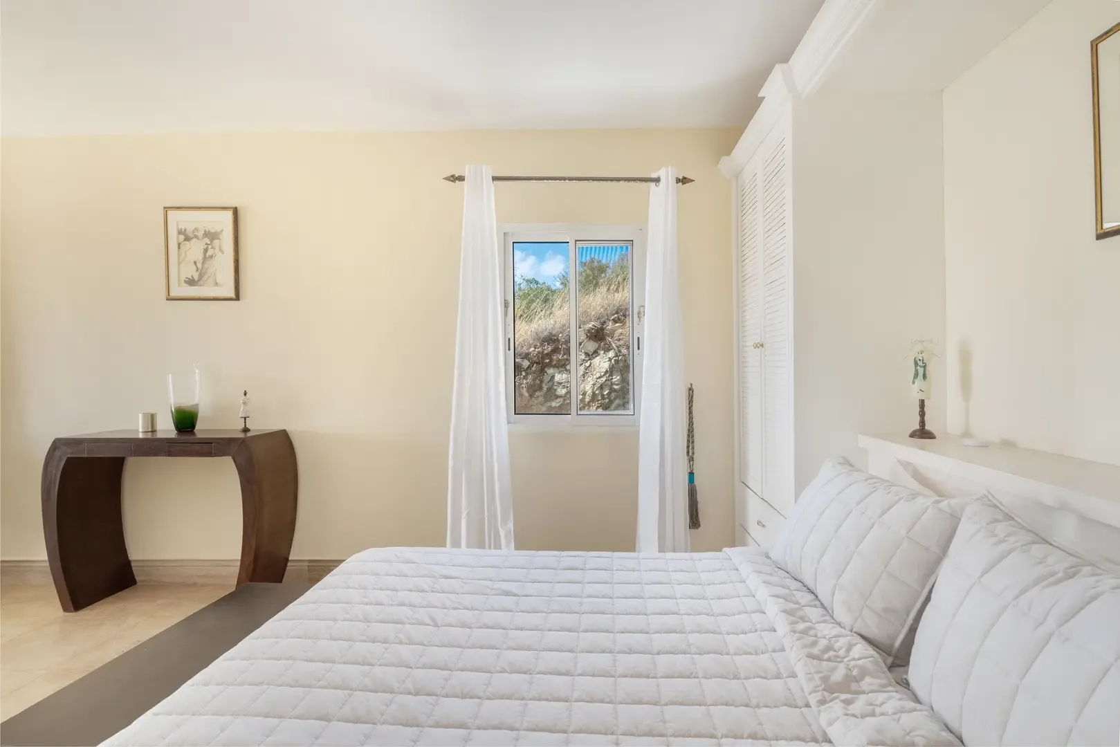 Crisp white linens and morning light — a peaceful retreat.