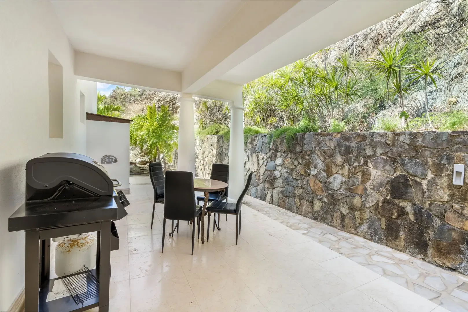 Covered patio with dining — outdoor meals with hillside views.