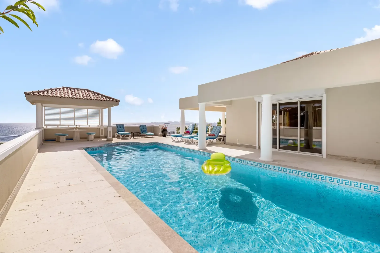 Swim, lounge, dine — your private pool opens to panoramic Caribbean views.