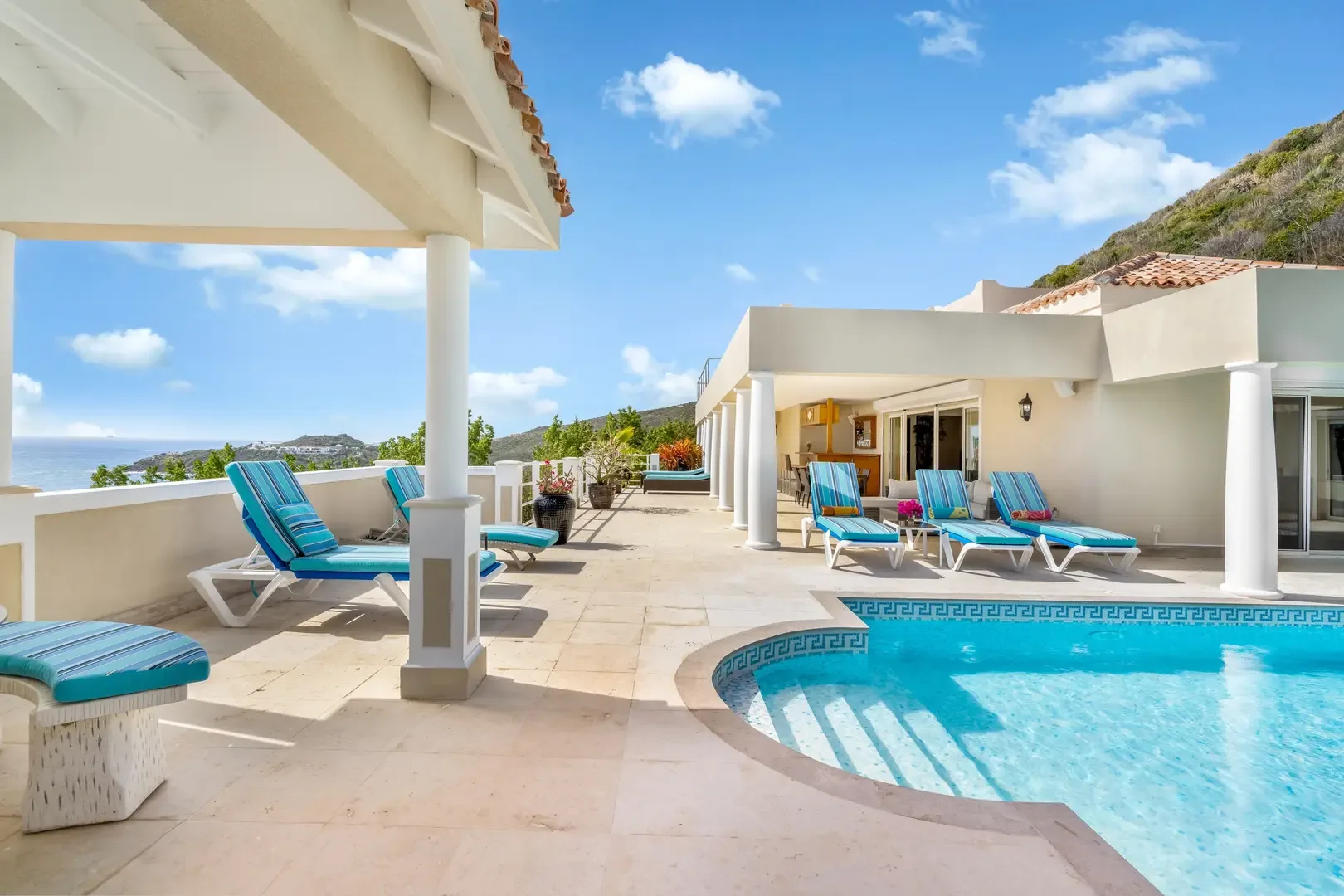 Indoor-outdoor living at its finest — your pool terrace opens to the Caribbean.