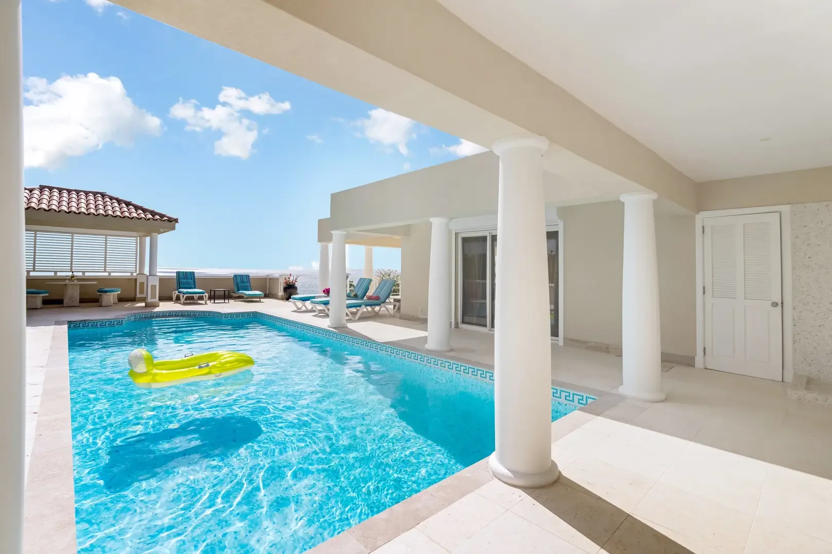 Your pool deck with lounge chairs — relax in the Caribbean sun.