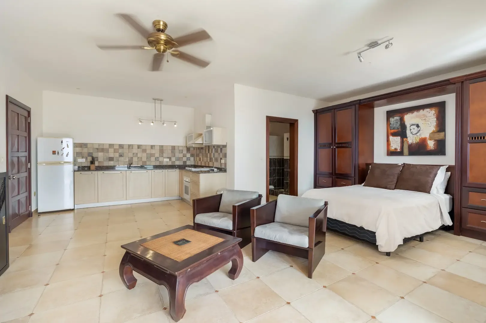 A complete studio apartment — living, sleeping, and kitchenette.