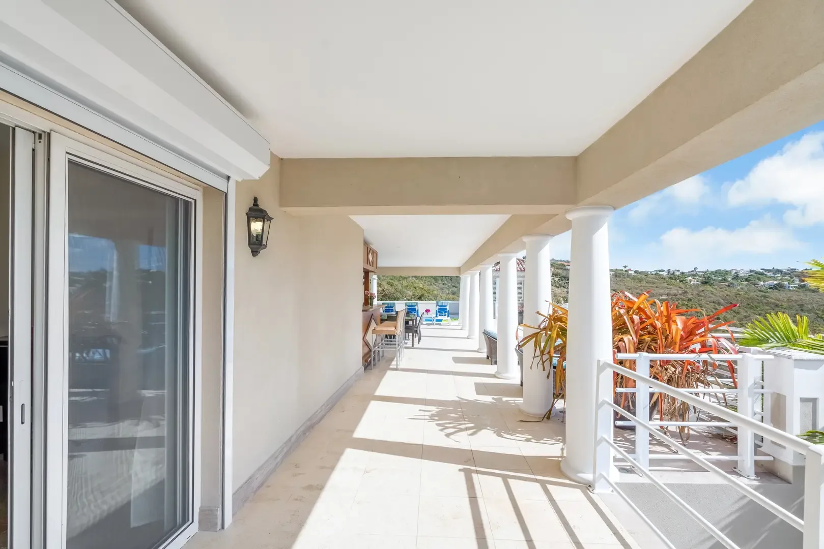 Stroll the colonnaded terrace — white columns frame hillside views.