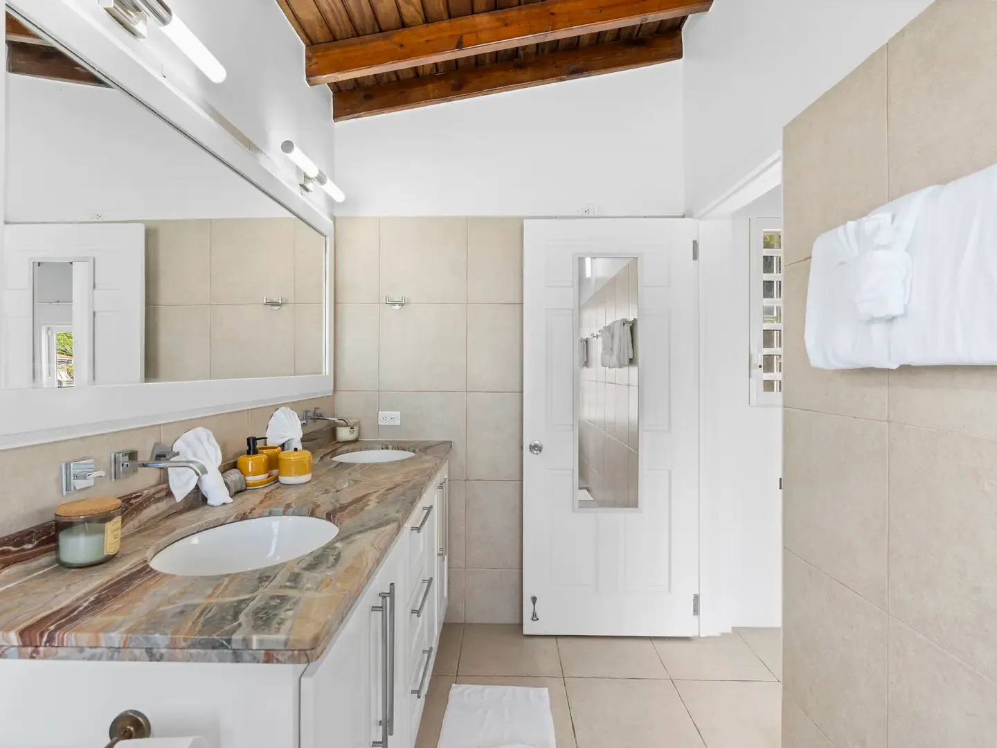 Get ready together at the double-sink vanity — marble countertops and warm lighting make vacation prep effortless.