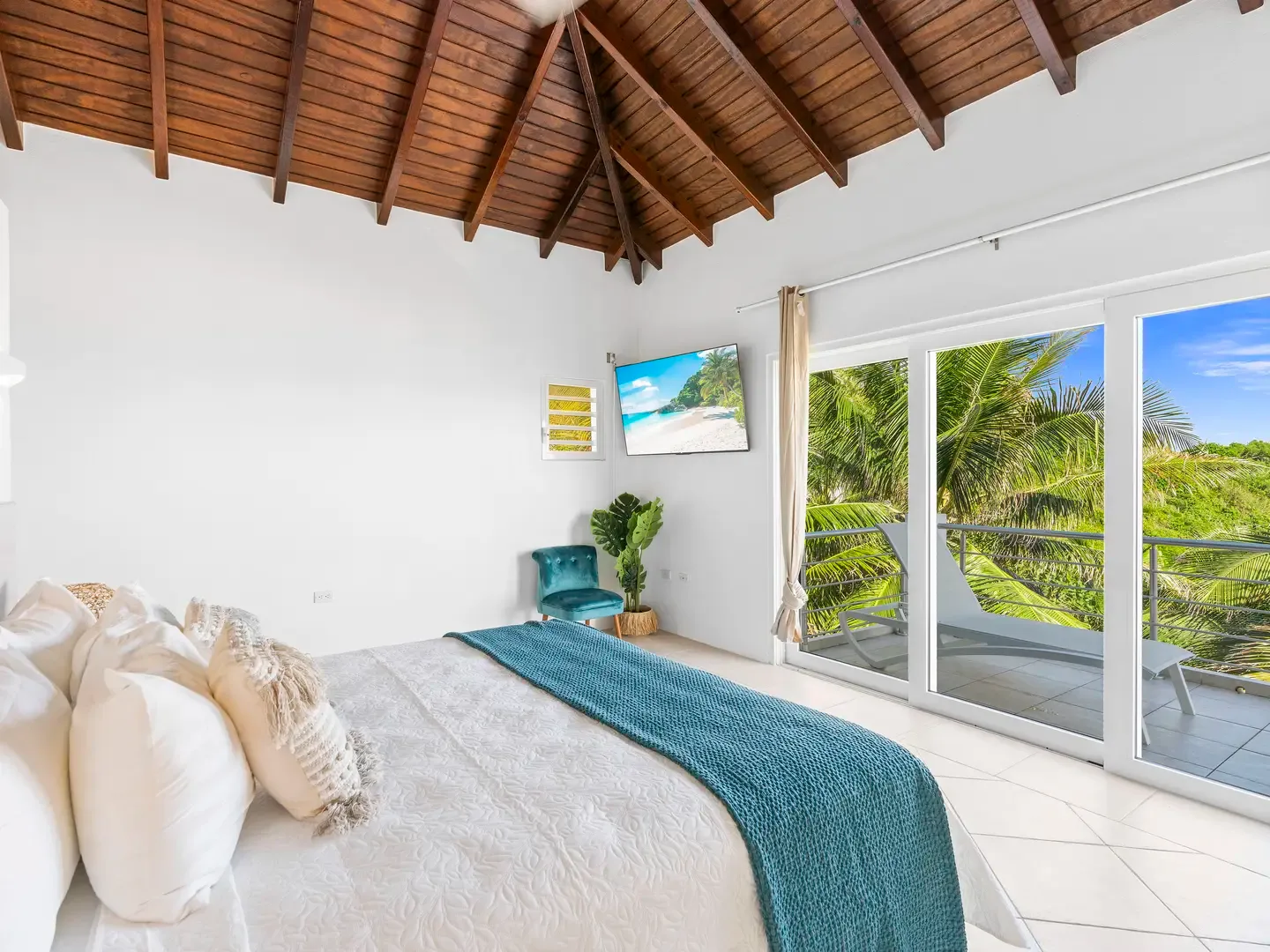 Step from your bedroom onto a private balcony with lounge chairs — your personal sunrise spot overlooking Dawn Beach.