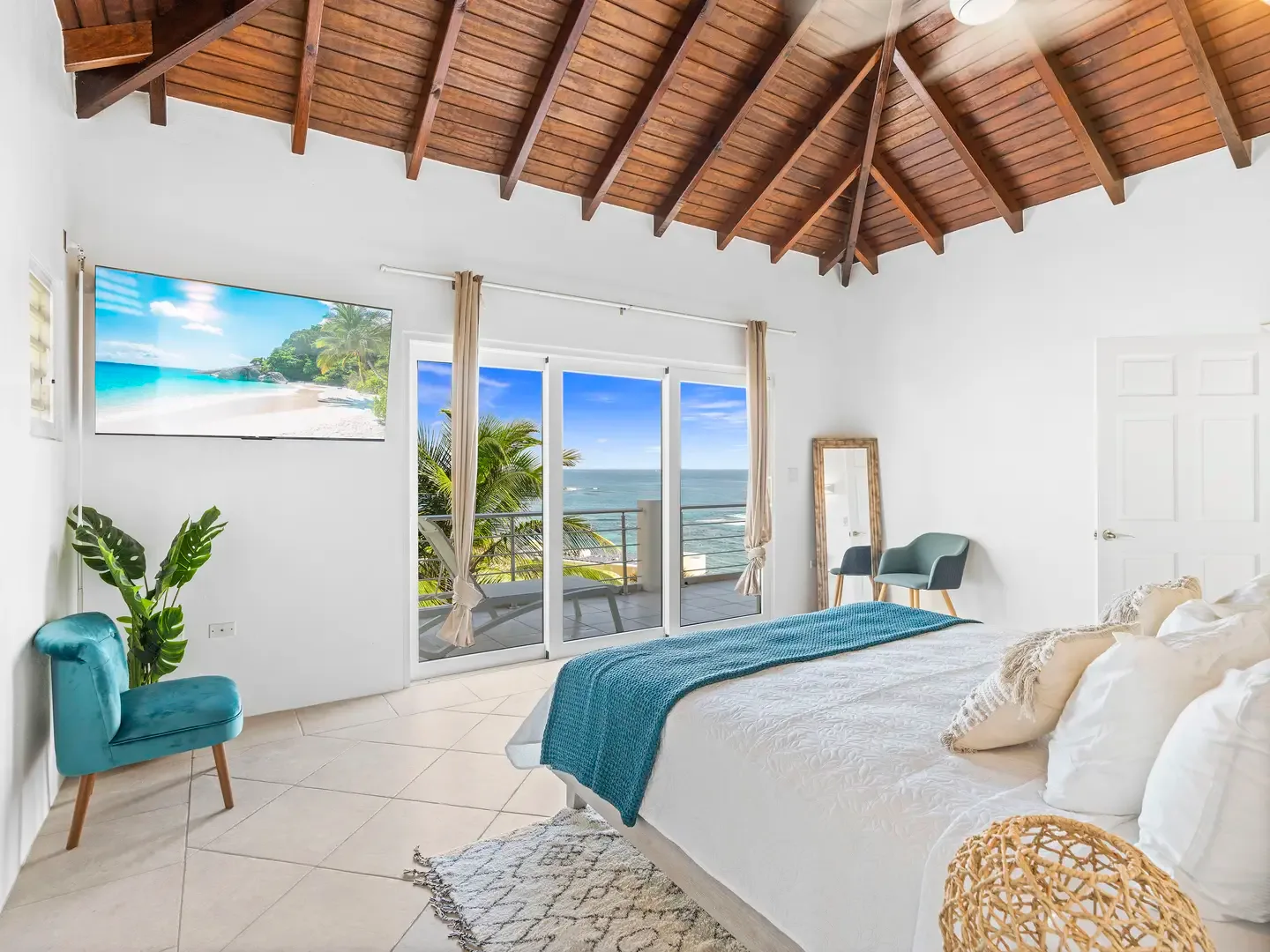 Turquoise accents echo the Caribbean waters just beyond your sliding doors — a bedroom designed for island dreaming.