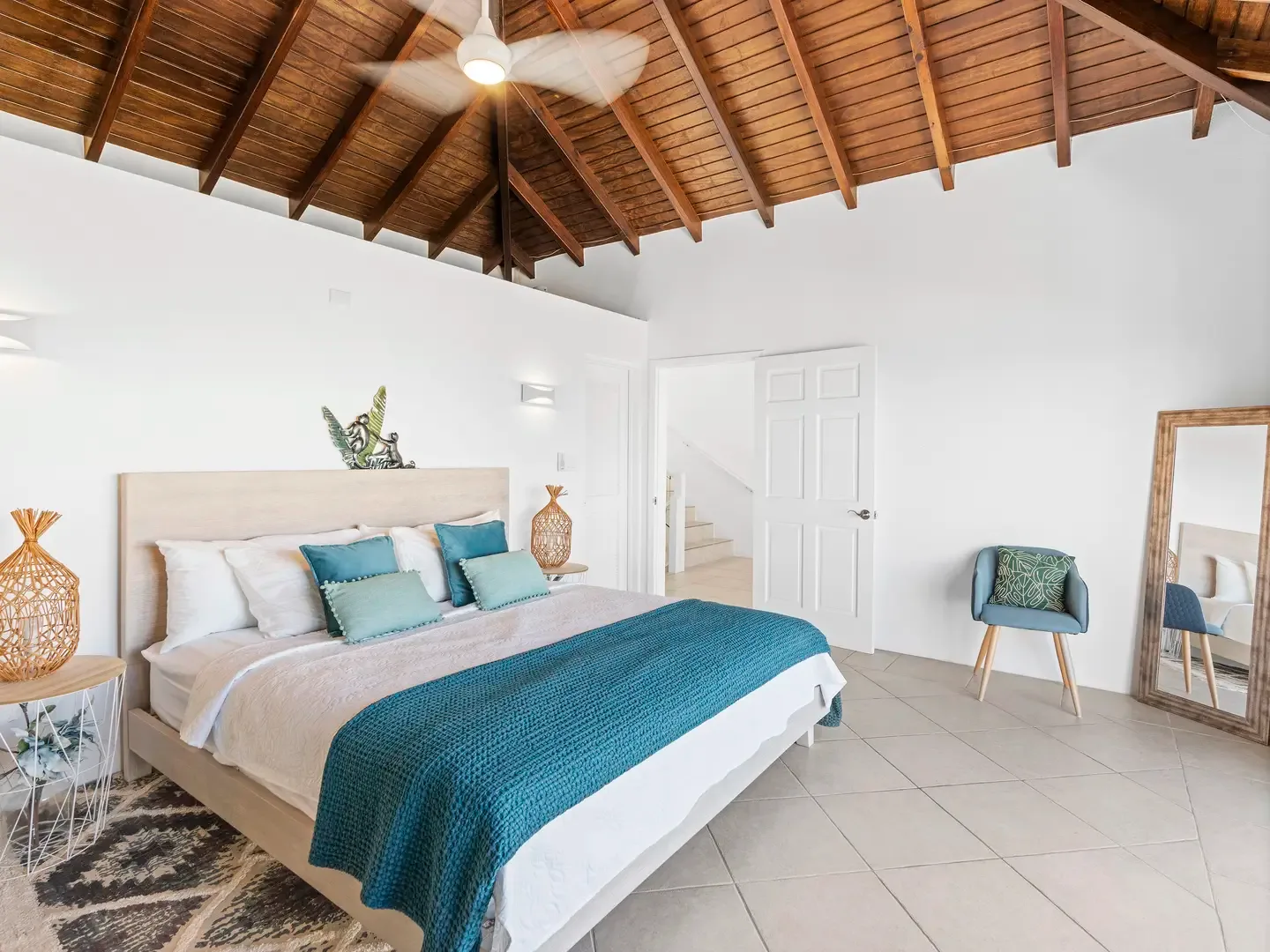 Rest easy in your spacious bedroom with vaulted wood-beam ceilings — Caribbean charm meets modern comfort.