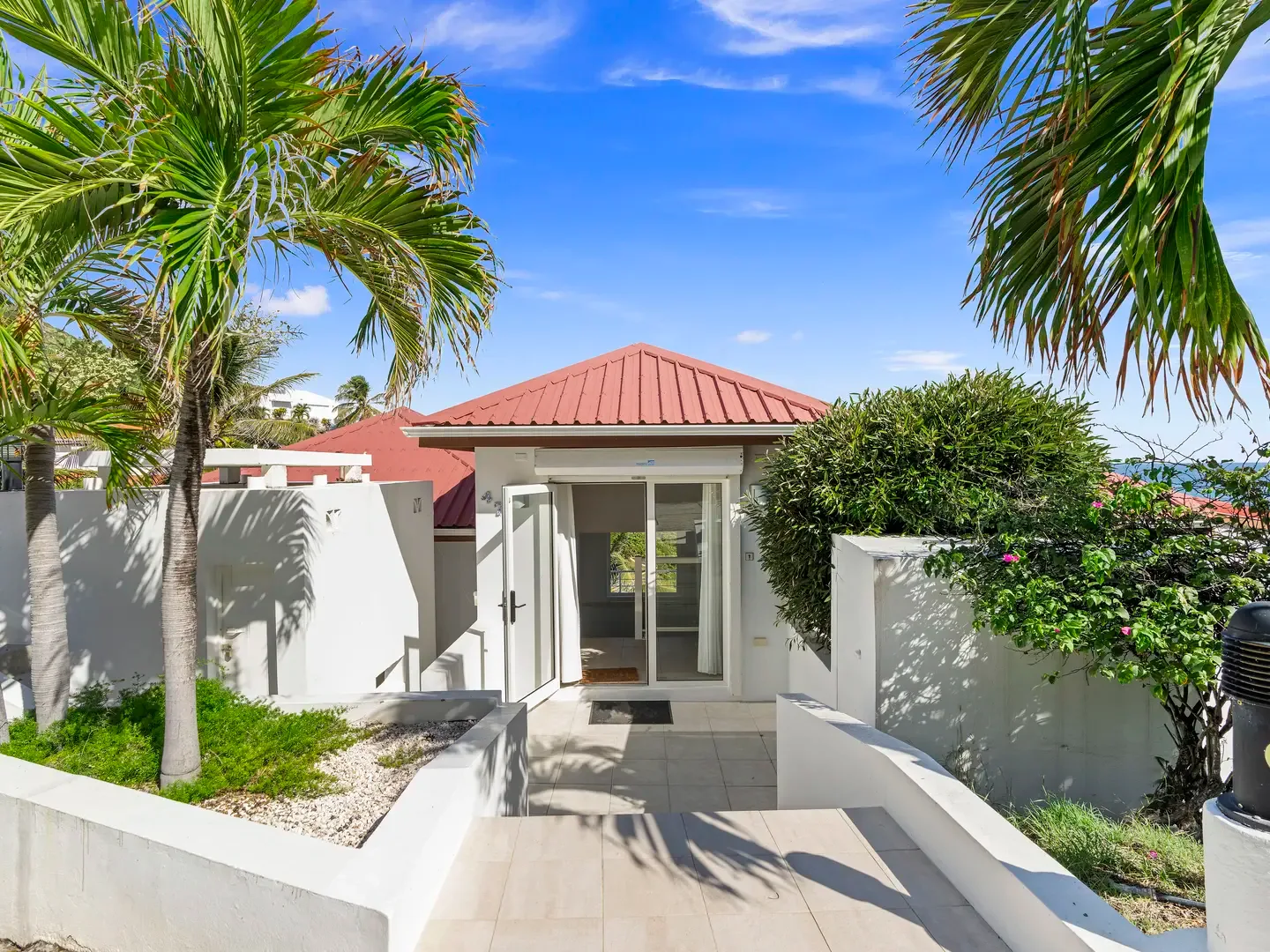 Welcome to Twin Palms — where swaying palm trees frame your entrance and the Caribbean Sea peeks through to greet you.