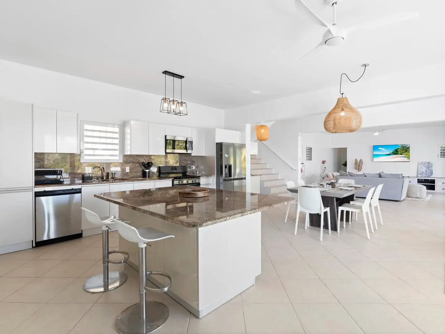 Morning coffee at the kitchen island with a view — your open-concept layout brings the Caribbean right to your breakfast.