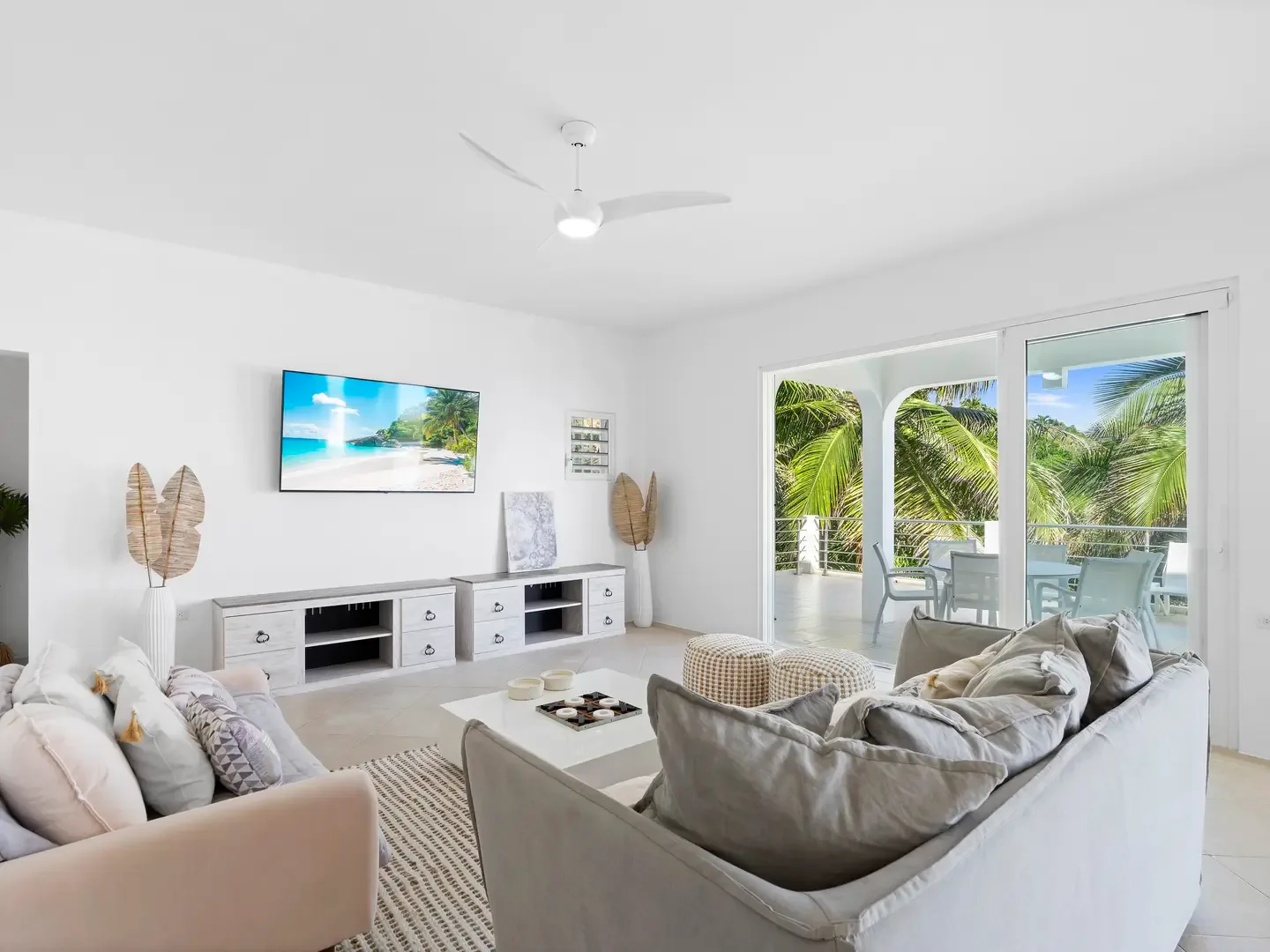 Unwind in your airy living room, where coastal colors and natural light create the perfect atmosphere for evening relaxation.