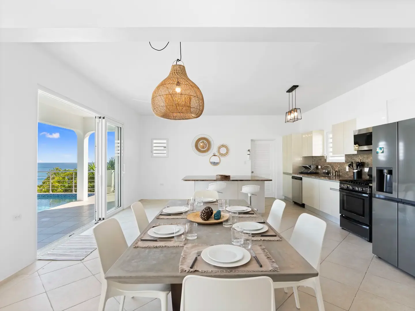 Cook with a view in your gourmet kitchen, where granite countertops and stainless appliances meet Caribbean vistas through sliding glass doors.