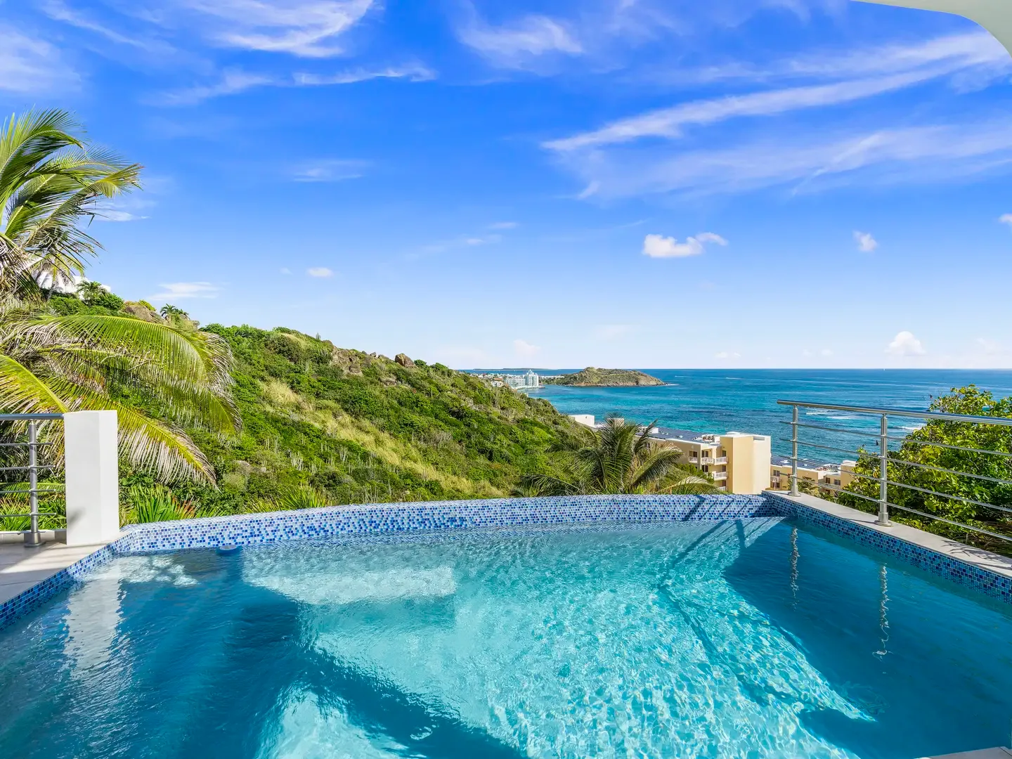 Your private infinity pool meets the Caribbean Sea — morning swims with panoramic ocean views and tropical breezes await.
