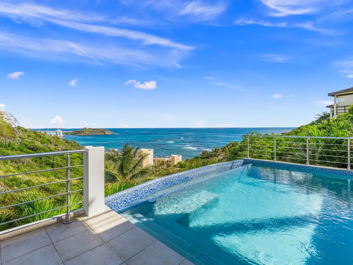 Lounge by your pool as the turquoise waters blend seamlessly with the ocean beyond — this is the island escape you've been dreaming of.