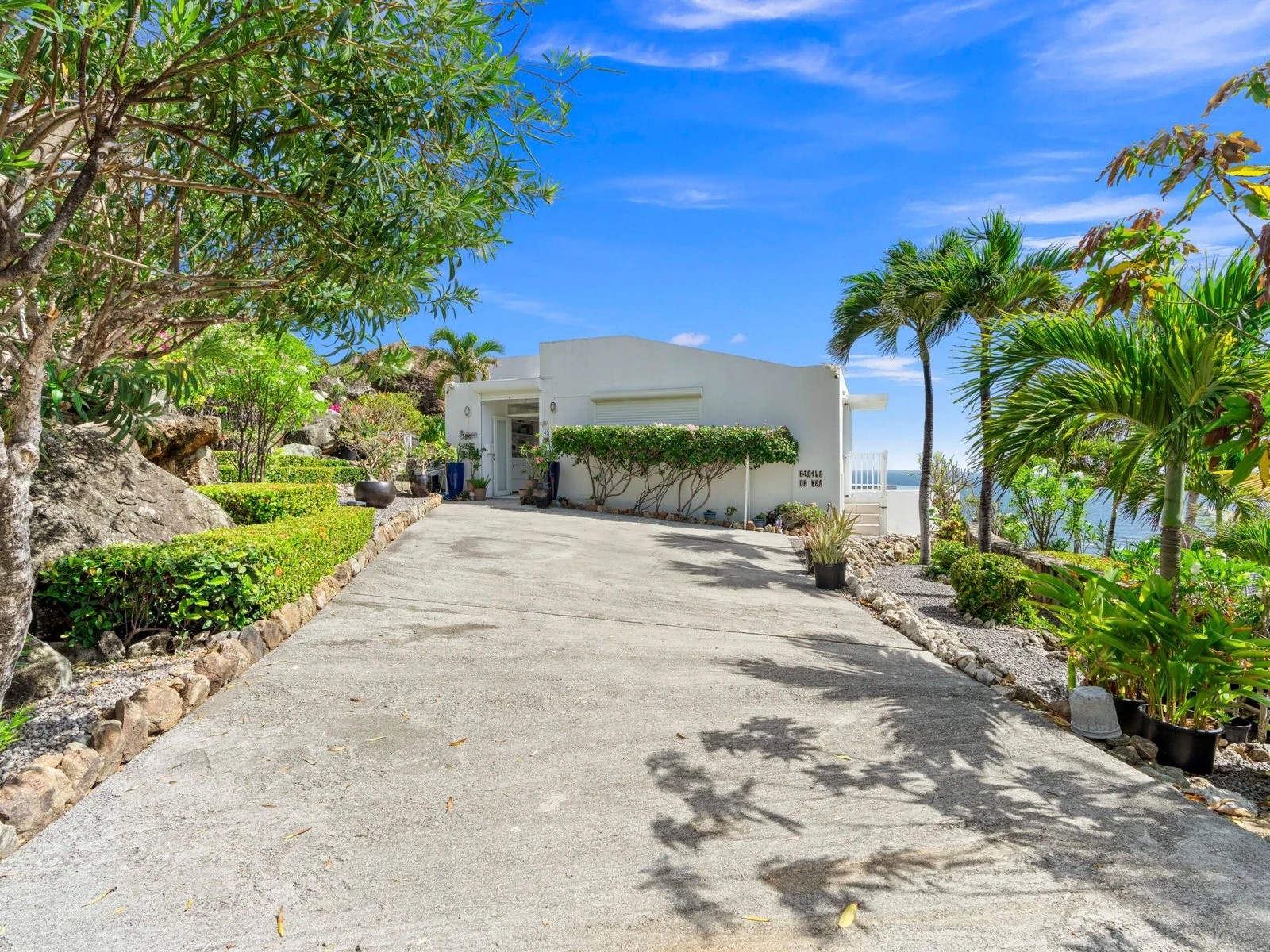 Villa entrance and tropical landscaping