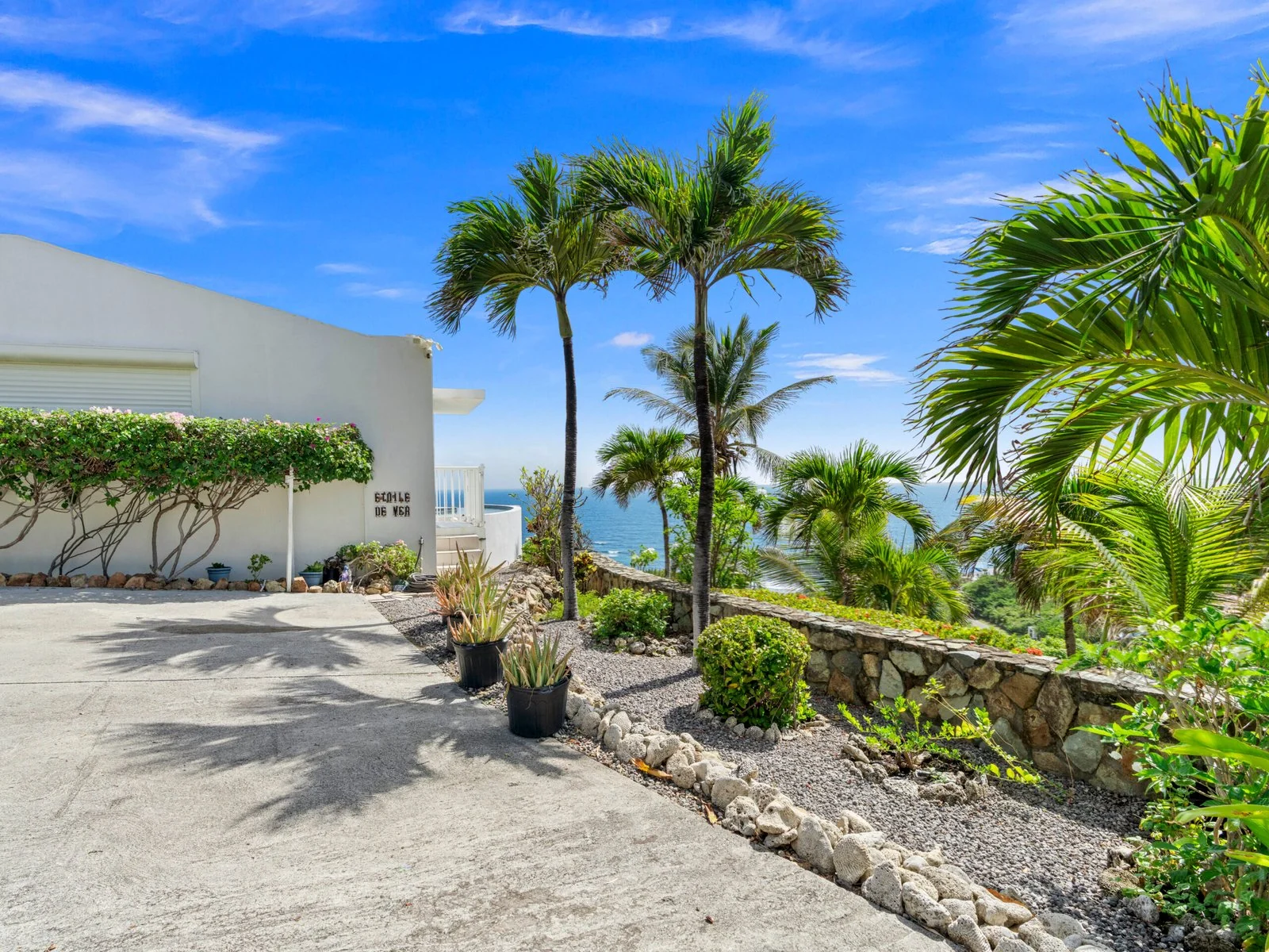 Villa entrance and tropical landscaping