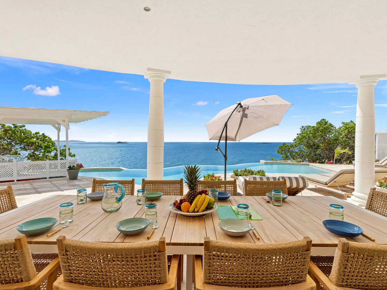 Covered terrace with outdoor dining and ocean views