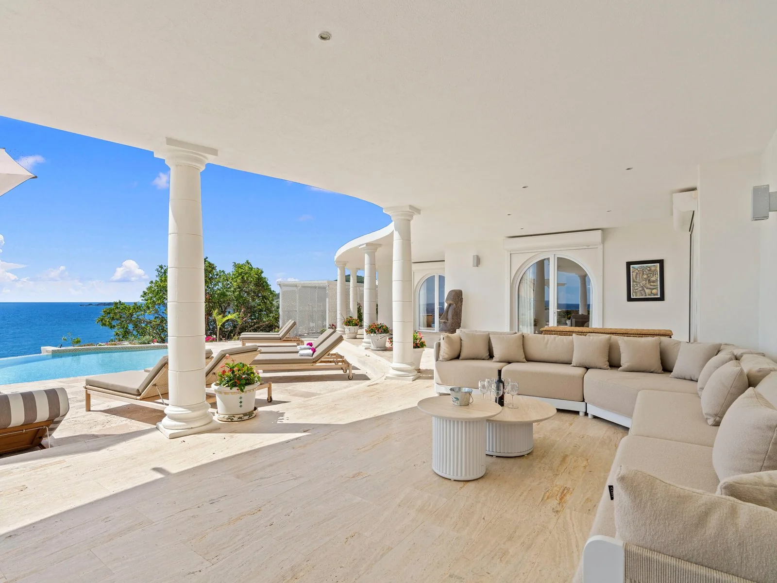 Covered terrace lounge overlooking the pool