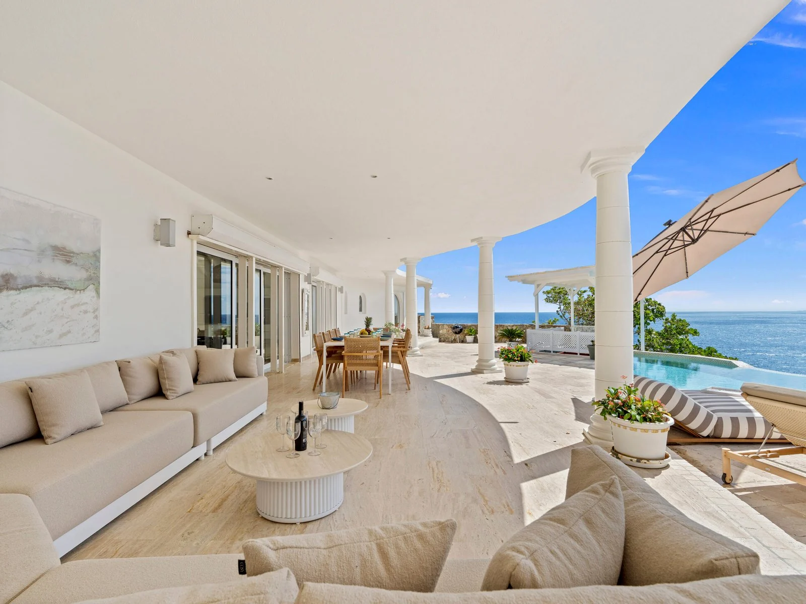 Covered terrace lounge overlooking the pool